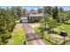 Charming two-story home features a drive, garage, deck, and fenced yard, with gated entry at 1151 Buttercup Rd, Elizabeth, CO 80107