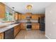 Updated kitchen with stainless steel appliances, wooden cabinets, and tile flooring at 1151 Buttercup Rd, Elizabeth, CO 80107