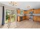 Bright kitchen with wood cabinets, stainless appliances, and sliding glass door at 1151 Buttercup Rd, Elizabeth, CO 80107