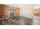 Living room featuring a fireplace, wood floors, and an open floorplan at 1151 Buttercup Rd, Elizabeth, CO 80107
