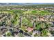 Expansive aerial view showing a home with mature trees and landscaping near park, field, and mountain views at 2093 S Holland St, Lakewood, CO 80227