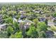 Aerial neighborhood view featuring tree lined streets, well-maintained houses, and green spaces at 2093 S Holland St, Lakewood, CO 80227