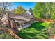 Aerial view of backyard showcasing patio, covered seating area, and well manicured lawn at 2093 S Holland St, Lakewood, CO 80227