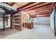 Unfinished basement featuring exposed wood beams and a concrete floor, ready for customization at 2093 S Holland St, Lakewood, CO 80227