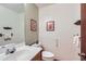 Powder room with a white vanity and sink, toilet, and decor at 2093 S Holland St, Lakewood, CO 80227