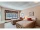 Bright bedroom with two twin beds, shuttered window, and neutral carpet at 2093 S Holland St, Lakewood, CO 80227