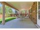 Inviting covered patio with furniture, overlooking the landscaped backyard and greenery at 2093 S Holland St, Lakewood, CO 80227