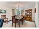 Formal dining room with elegant chandelier, large window, and a classic china cabinet at 2093 S Holland St, Lakewood, CO 80227