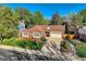 Beautiful brick home with mature trees, landscaping, a large driveway and two car garage at 2093 S Holland St, Lakewood, CO 80227