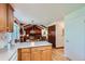 Open layout: the kitchen island leads to a living area featuring wood-paneled walls and a fireplace at 2093 S Holland St, Lakewood, CO 80227