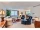 Spacious living room with a large sectional sofa, plush armchairs, and a view into dining area at 2093 S Holland St, Lakewood, CO 80227