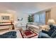 Bright living room with large sectional sofa, coffee table, and natural light at 2093 S Holland St, Lakewood, CO 80227