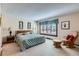 Spacious main bedroom featuring a large window, light blue accents, and comfortable sitting area at 2093 S Holland St, Lakewood, CO 80227