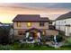 Two-story home showcasing a covered patio, manicured lawn, and outdoor seating areas ideal for relaxing and entertaining at 2575 Mccracken Ln, Castle Rock, CO 80104