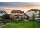 Backyard with green lawn and stone patio at 2575 Mccracken Ln, Castle Rock, CO 80104