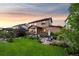 Expansive backyard boasts lush lawn, landscaped garden beds, and multiple patio areas for outdoor enjoyment at 2575 Mccracken Ln, Castle Rock, CO 80104