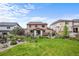 Large backyard with stone patio, expansive lawn, and meticulous landscaping at 2575 Mccracken Ln, Castle Rock, CO 80104