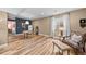 Finished basement with a dining area, hardwood floors, and an adjacent sitting area with a cushioned bench at 2575 Mccracken Ln, Castle Rock, CO 80104