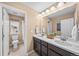 Well-lit bathroom boasts a double sink vanity and a separate toilet room for added privacy at 2575 Mccracken Ln, Castle Rock, CO 80104