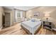 Cozy bedroom with a double bed, light hardwood flooring, and warm lighting at 2575 Mccracken Ln, Castle Rock, CO 80104