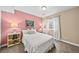 Comfortable bedroom featuring soft carpet, a plush bed, and light pink accent wall at 2575 Mccracken Ln, Castle Rock, CO 80104