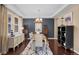 Elegant dining room with modern lighting, a large table, and dark wood flooring at 2575 Mccracken Ln, Castle Rock, CO 80104