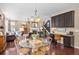 Open-concept dining area with hardwood floors, a chandelier, a desk and seamlessly connecting to the living space at 2575 Mccracken Ln, Castle Rock, CO 80104