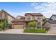 Inviting two-story home featuring stone accents, manicured lawn, and attached two car garage at 2575 Mccracken Ln, Castle Rock, CO 80104