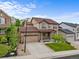 Beautiful two-story home featuring a stone facade, well-manicured lawn, and an attached two-car garage at 2575 Mccracken Ln, Castle Rock, CO 80104
