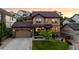 Charming two-story home features a well-manicured lawn, stone accents, and an attached two-car garage at 2575 Mccracken Ln, Castle Rock, CO 80104