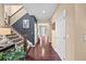 Inviting foyer showcasing hardwood floors, a staircase with iron railings, and a view of the entrance at 2575 Mccracken Ln, Castle Rock, CO 80104