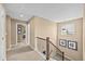 Upstairs hallway with neutral carpeting and a railing overlooking the staircase, complemented by natural light at 2575 Mccracken Ln, Castle Rock, CO 80104