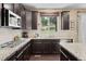 Well-equipped kitchen with granite countertops, dark wood cabinets, and stainless steel appliances at 2575 Mccracken Ln, Castle Rock, CO 80104