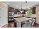 Well-equipped kitchen with dark wood cabinetry, granite countertops, an island and stainless steel appliances at 2575 Mccracken Ln, Castle Rock, CO 80104