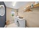 Functional laundry room equipped with a washer, dryer, shelving, and a window for natural light at 2575 Mccracken Ln, Castle Rock, CO 80104