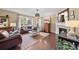 Bright living room with hardwood floors, fireplace, and a large window providing ample natural light at 2575 Mccracken Ln, Castle Rock, CO 80104