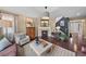 Cozy living room with a fireplace, hardwood floors, and decorative lighting at 2575 Mccracken Ln, Castle Rock, CO 80104