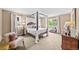 Main bedroom with four poster bed, hardwood floors, and natural light at 2575 Mccracken Ln, Castle Rock, CO 80104