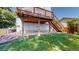 Exterior view of the home's deck and backyard with new grass at 3755 Shefield Dr, Broomfield, CO 80020