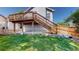 Exterior view of the home's deck and backyard with new grass at 3755 Shefield Dr, Broomfield, CO 80020