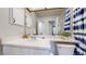 Bathroom featuring a white vanity, ample storage, and well lit mirror at 3755 Shefield Dr, Broomfield, CO 80020