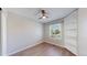 Cozy bedroom featuring a window, ceiling fan, and built in bookcase at 3755 Shefield Dr, Broomfield, CO 80020