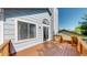 Wooden deck area with blue siding and lush trees, offering a secluded outdoor space at 3755 Shefield Dr, Broomfield, CO 80020