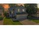 Two-story home with a well-manicured lawn and an attached two-car garage at sunset at 3755 Shefield Dr, Broomfield, CO 80020