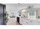 Bright, open kitchen featuring white cabinetry, island with breakfast bar, and seamless flow into the living area at 3755 Shefield Dr, Broomfield, CO 80020