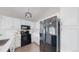 Stylish kitchen with white cabinets, stainless steel appliances, and modern lighting at 3755 Shefield Dr, Broomfield, CO 80020