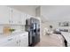 Modern kitchen with white cabinets, marble countertop, and stainless steel refrigerator at 3755 Shefield Dr, Broomfield, CO 80020
