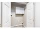 A laundry room with overhead cabinets and tile flooring at 3755 Shefield Dr, Broomfield, CO 80020