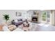 Cozy living room featuring a brick fireplace, modern sofa, and stylish decor at 3755 Shefield Dr, Broomfield, CO 80020