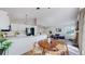 Bright open-concept living space with dining area, modern decor, and white cabinetry at 3755 Shefield Dr, Broomfield, CO 80020